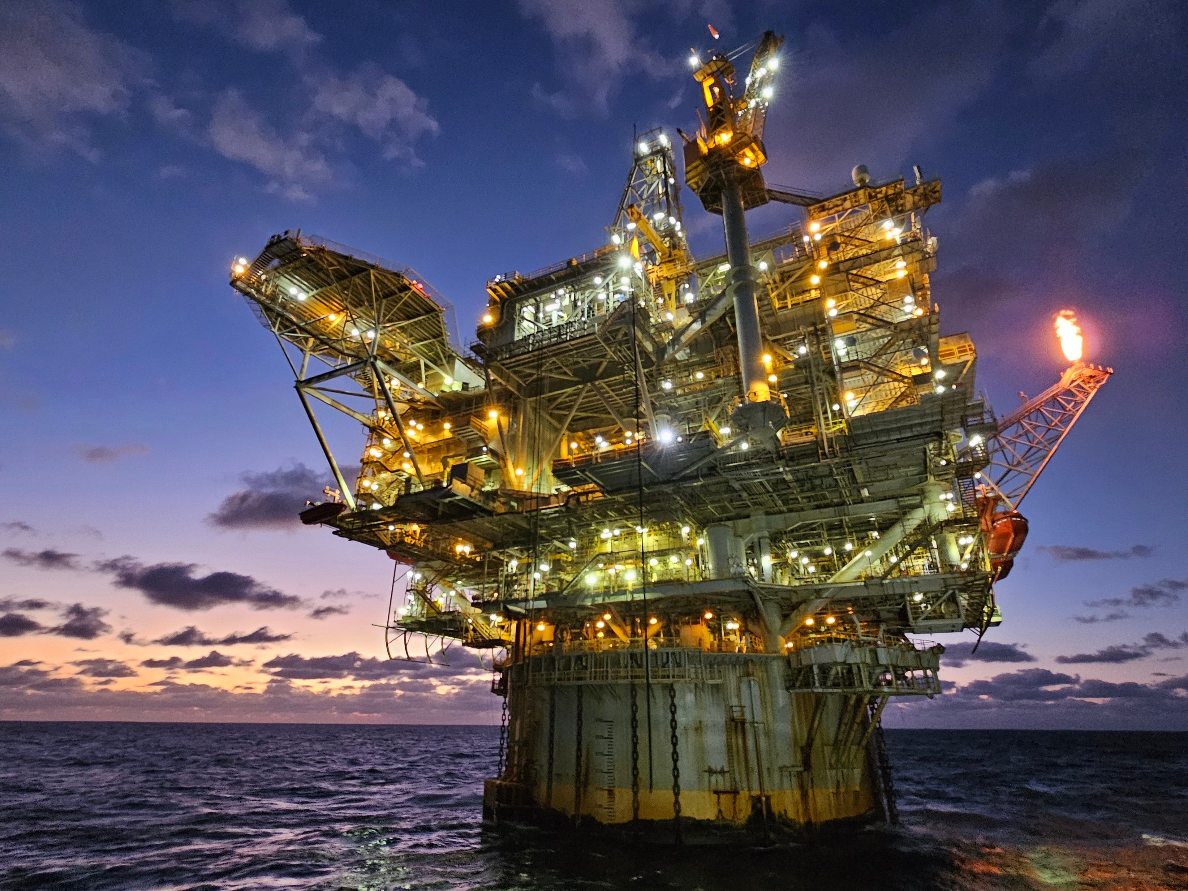 Offshore oil platform at dusk — the edge of the known world